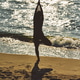 Silhouette of person practicing yoga tree pose on Baltic Sea beach at sunset Silhouette of person practicing yoga tree pose on Baltic Sea beach at sunset - PhotoDune Item for Sale