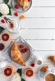 Flat lay of a breakfast table with croissants and coffee on a white wooden table Flat lay of a breakfast table with croissants and coffee on a white wooden table - PhotoDune Item for Sale