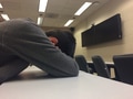 Tired college student fell asleep in the classroom table. Tired college student fell asleep in the classroom table. - PhotoDune Item for Sale