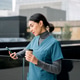 Healthcare worker using phone drinking coffee outdoors Healthcare worker using phone drinking coffee outdoors - PhotoDune Item for Sale