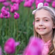 Adorable little caucasian blonde girl smiling in tulip field at spring day Adorable little caucasian blonde girl smiling in tulip field at spring day - PhotoDune Item for Sale