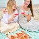 Young adult girlfriends enjoying pink wine and pizza picnic on pebble beach Young adult girlfriends enjoying pink wine and pizza picnic on pebble beach - PhotoDune Item for Sale