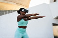 Happy fit African woman using futuristic virtual reality glasses during training session Happy fit African woman using futuristic virtual reality glasses during training session - PhotoDune Item for Sale