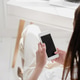 Back view of young business woman holding smartphone and looking at screen. Back view of young business woman holding smartphone and looking at screen. - PhotoDune Item for Sale