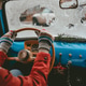 driver in a red jacket rides a blue retro car behind the wheel driver in a red jacket rides a blue retro car behind the wheel - PhotoDune Item for Sale