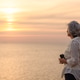Senior Woman Enjoying Sunset by the Sea with Binoculars Senior Woman Enjoying Sunset by the Sea with Binoculars - PhotoDune Item for Sale