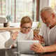 Grandson and grandfather speaking through video chat app using tablet. Grandson and grandfather speaking through video chat app using tablet. - PhotoDune Item for Sale