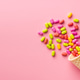 Colorful hard mint Candies in ice cream cone on pink background. Top view. Colorful hard mint Candies in ice cream cone on pink background. Top view. - PhotoDune Item for Sale