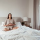 Calm young woman practicing deep breathing meditation at home in bedroom Calm young woman practicing deep breathing meditation at home in bedroom - PhotoDune Item for Sale
