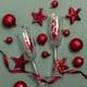 Champagne Flutes and Red Christmas Decorations on Green Background Champagne Flutes and Red Christmas Decorations on Green Background - PhotoDune Item for Sale