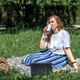 A middle-aged woman had a picnic in a city park during her work break. Summer A middle-aged woman had a picnic in a city park during her work break. Summer - PhotoDune Item for Sale