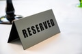 Table at restaurant with reserved sign close-up Table at restaurant with reserved sign close-up - PhotoDune Item for Sale