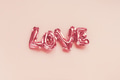 Love concept. Inflatable pink balloon with letters Love concept. Inflatable pink balloon with letters - PhotoDune Item for Sale