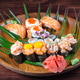 Sushi and rolls with raw quail eggs on wooden plate with green leaves Sushi and rolls with raw quail eggs on wooden plate with green leaves - PhotoDune Item for Sale