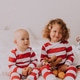 children in red and white pajamas play, have fun, make faces in bed. Lifestyle children in red and white pajamas play, have fun, make faces in bed. Lifestyle - PhotoDune Item for Sale