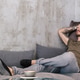 Young man with tattoos resting on a stylish gray couch in an urban apartment Young man with tattoos resting on a stylish gray couch in an urban apartment - PhotoDune Item for Sale