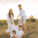 Happy young family with two children having fun in park on a sunny day Happy young family with two children having fun in park on a sunny day - PhotoDune Item for Sale