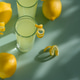 Limoncello Glasses with Curled Lemon Peels and Fresh Lemons on Light Green Background. Limoncello Glasses with Curled Lemon Peels and Fresh Lemons on Light Green Background. - PhotoDune Item for Sale