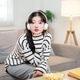 A pretty Asian woman wearing headphones, sitting on a sofa and looking directly at the camera. A pretty Asian woman wearing headphones, sitting on a sofa and looking directly at the camera. - PhotoDune Item for Sale