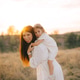 Cute young daughter on a piggy back ride with her mother. Cute young daughter on a piggy back ride with her mother. - PhotoDune Item for Sale