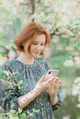 Young redhaired beautiful woman wear casual dress texting with smartphone. Young redhaired beautiful woman wear casual dress texting with smartphone. - PhotoDune Item for Sale