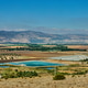 Irrigation ponds and cultivated fields stretch beneath distant hills Irrigation ponds and cultivated fields stretch beneath distant hills - PhotoDune Item for Sale