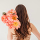 Woman with long brown hair adorned with vibrant pink flowers on shoulder Woman with long brown hair adorned with vibrant pink flowers on shoulder - PhotoDune Item for Sale