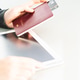 Close up of women hand holding passport with tablet computer blank space screen Close up of women hand holding passport with tablet computer blank space screen - PhotoDune Item for Sale