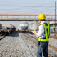 Railway Engineer Inspecting Tanker Trains at Rail Yard Railway Engineer Inspecting Tanker Trains at Rail Yard - PhotoDune Item for Sale