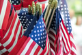 Closeup view of many United States flags ready for July 4 Independence Day patriotic celebration. Closeup view of many United States flags ready for July 4 Independence Day patriotic celebration. - PhotoDune Item for Sale