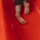 barefoot child climbs a slide in the playground barefoot child climbs a slide in the playground - PhotoDune Item for Sale