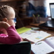 Little girl in eyelgasses studying online and using her laptop at home Little girl in eyelgasses studying online and using her laptop at home - PhotoDune Item for Sale