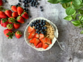 Flat lay of healthy oatmeal, strawberries and blueberries breakfast on gray surface and plant Flat lay of healthy oatmeal, strawberries and blueberries breakfast on gray surface and plant - PhotoDune Item for Sale