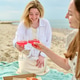 Young women sharing pink wine and pizza during sunny beach picnic Young women sharing pink wine and pizza during sunny beach picnic - PhotoDune Item for Sale