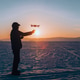 launching or landing drone after a flight in winter at sunset in the evening. a man catches a drone. launching or landing drone after a flight in winter at sunset in the evening. a man catches a drone. - PhotoDune Item for Sale
