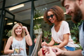 Small group of friends enjoying at outdoor cafe Small group of friends enjoying at outdoor cafe - PhotoDune Item for Sale