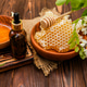 Blooming tree with fragrant flowers and honeycomb on wooden table with oil dropper in spring season Blooming tree with fragrant flowers and honeycomb on wooden table with oil dropper in spring season - PhotoDune Item for Sale