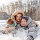 Smiling mother with teen son, maltipoo dog lying in deep snow, hugging, posing for camera. Happy Smiling mother with teen son, maltipoo dog lying in deep snow, hugging, posing for camera. Happy - PhotoDune Item for Sale