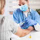Young female doctor vaccinating elderly patient in UK GP's office Young female doctor vaccinating elderly patient in UK GP's office - PhotoDune Item for Sale