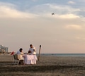 Cute Hispanic Latino couple having candle light romantic engagement dinner at beach during sunset Cute Hispanic Latino couple having candle light romantic engagement dinner at beach during sunset - PhotoDune Item for Sale