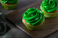 Chocolate cupcakes with green whipped cream and chocolate sprinkles. Chocolate cupcakes with green whipped cream and chocolate sprinkles. - PhotoDune Item for Sale