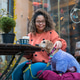 Woman petting dachshund dog at outdoor cafe in dresden Woman petting dachshund dog at outdoor cafe in dresden - PhotoDune Item for Sale