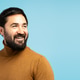Smiling bearded man looking away on blue background Smiling bearded man looking away on blue background - PhotoDune Item for Sale