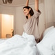 Happy woman stretching in bed after waking up, morning routine and healthy lifestyle Happy woman stretching in bed after waking up, morning routine and healthy lifestyle - PhotoDune Item for Sale