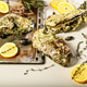 Giant fresh Pacific oysters on a light background. Lemon and oregano. Selective focus. Copy space Giant fresh Pacific oysters on a light background. Lemon and oregano. Selective focus. Copy space - PhotoDune Item for Sale