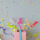 Creative composition made with gift box and party streamers on pastel grey background. Creative composition made with gift box and party streamers on pastel grey background. - PhotoDune Item for Sale