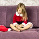 Cute girl Santa Claus is sitting on the sofa close up blonde long hair loose Santa Claus cap tired h Cute girl Santa Claus is sitting on the sofa close up blonde long hair loose Santa Claus cap tired h - PhotoDune Item for Sale