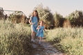 Two sisters running in summer grass field with scenic path Two sisters running in summer grass field with scenic path - PhotoDune Item for Sale