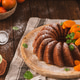 Glazed Orange Bundt Cake with Powdered Sugar and Fresh Mint on a Rustic Wooden Table Glazed Orange Bundt Cake with Powdered Sugar and Fresh Mint on a Rustic Wooden Table - PhotoDune Item for Sale