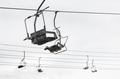Empty chairlift with cloudy sky in the background Empty chairlift with cloudy sky in the background - PhotoDune Item for Sale